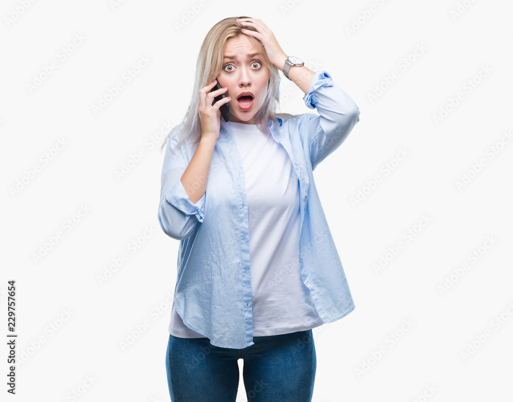 Young blonde woman talking using smarpthone over isolated background stressed with hand on head, shocked with shame and surprise face, angry and frustrated. Fear and upset for mistake. Young blonde woman talking using smarpthone over isolated background stressed with hand on head, shocked with shame and surprise face, angry and frustrated. Fear and upset for mistake.