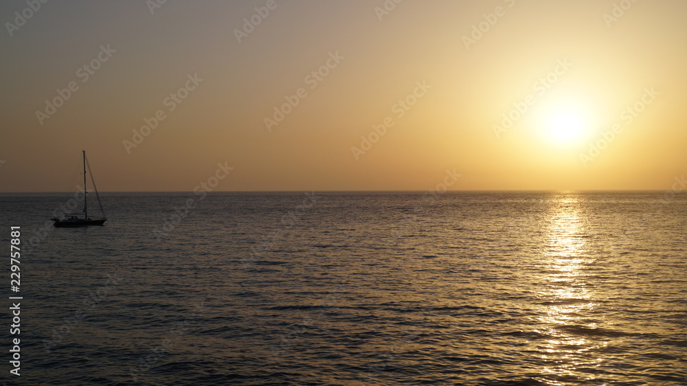 Sunset over Pacific Carribean beach showing dramatic red and yellow sky as sun sets Sunset over Pacific Carribean beach showing dramatic red and yellow sky as sun sets