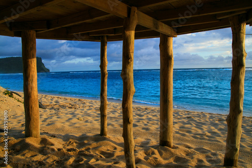 Fototapeta Naklejka Na Ścianę i Meble -  Deep blue waters of Pacific Ocean wiev through wooden pillars of beach fale - traditional Samoan house Lalomanu beach Samoa, Polynesia