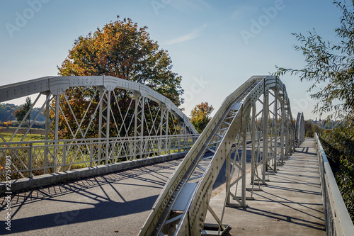 old metal bridge with railing and shadows © Normunds