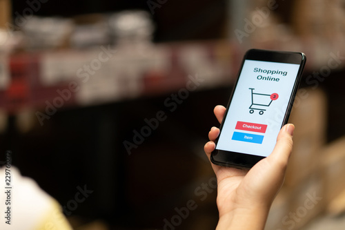 Online shopping with smartphone and shopping bags delivery service using as background shopping concept and delivery service concept with copy space for your text or design.