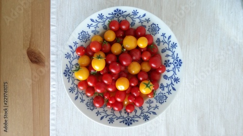 Plate full of red and yellow tomatos grown on balcony