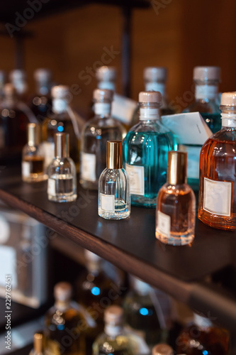 Colorful bottles with perfumes. Perfume bottles at store shelves