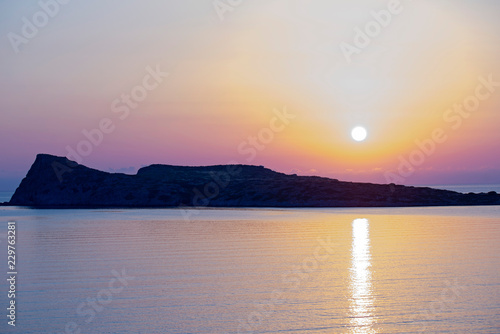 Sunrise on the beach, early morning in Kolokitha island, Crete, Greece