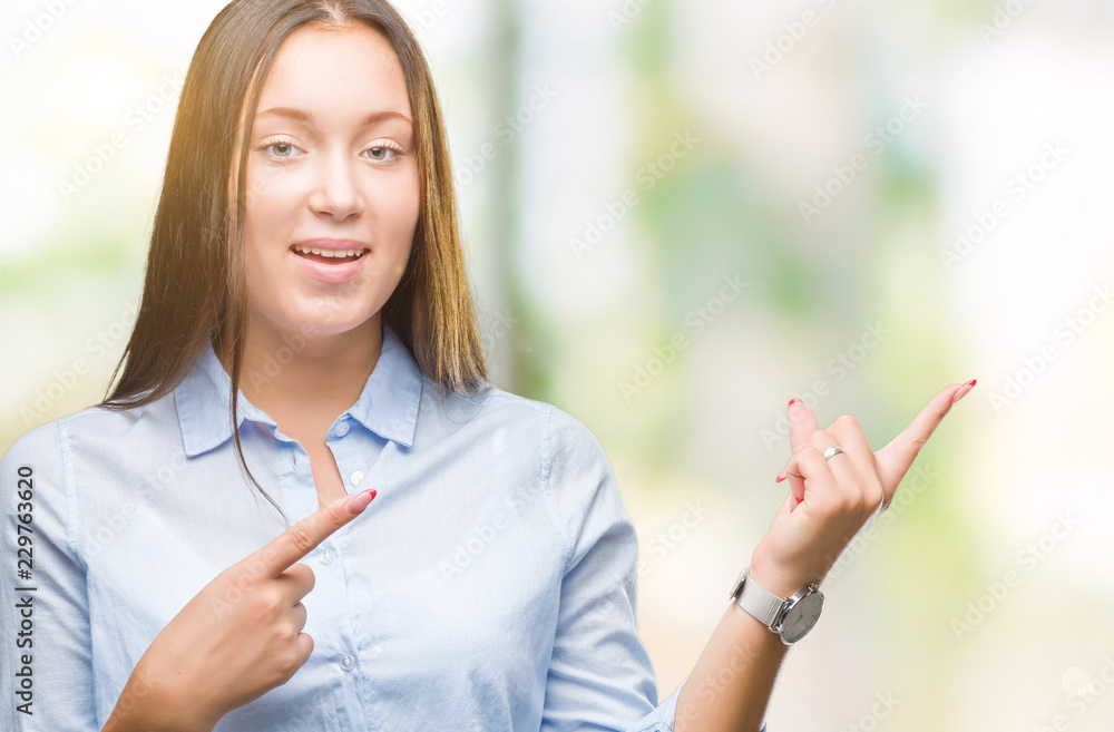 Young caucasian beautiful woman over isolated background smiling and looking at the camera pointing with two hands and fingers to the side. Young caucasian beautiful woman over isolated background smiling and looking at the camera pointing with two hands and fingers to the side.