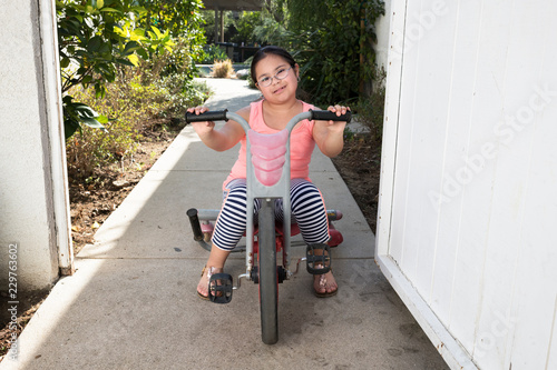 Girl riding tricycle