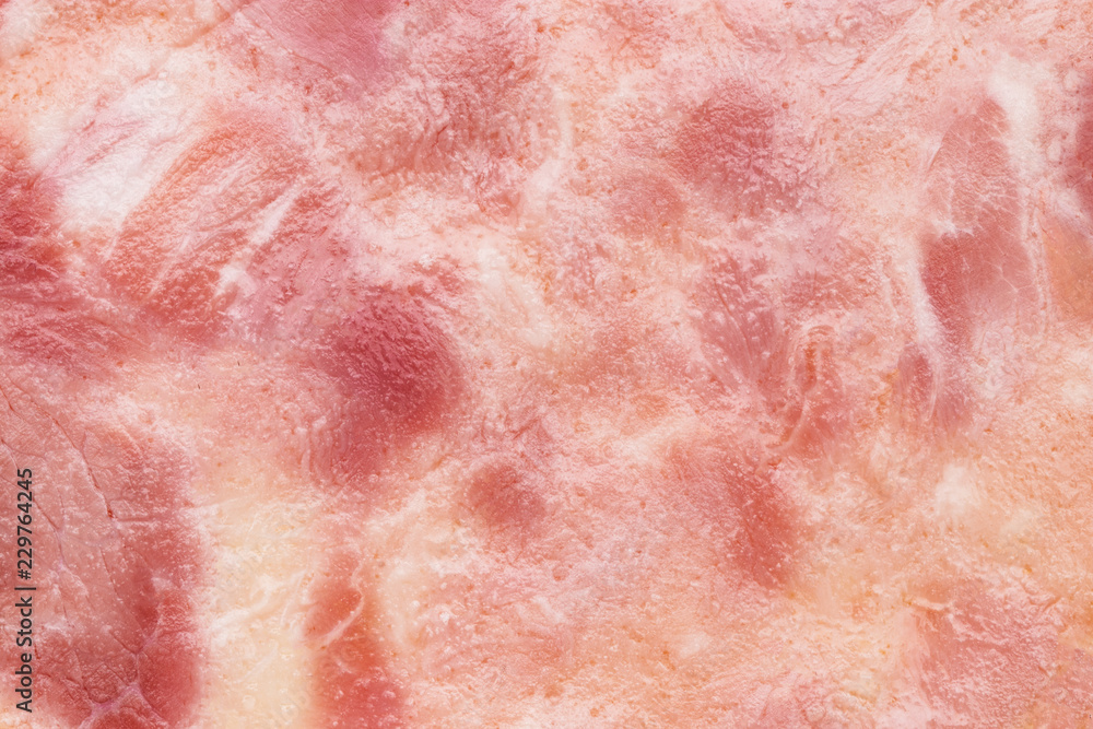 Close-up fragment of ham meat as a background texture composition Close-up fragment of ham meat as a background texture composition