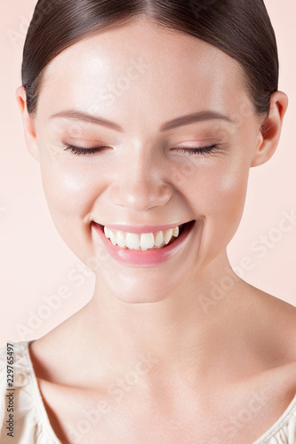 Young smiling woman with clean perfect skin close-up