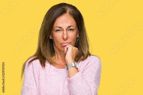 Beautiful middle age adult woman wearing winter sweater over isolated background thinking looking tired and bored with depression problems with crossed arms.