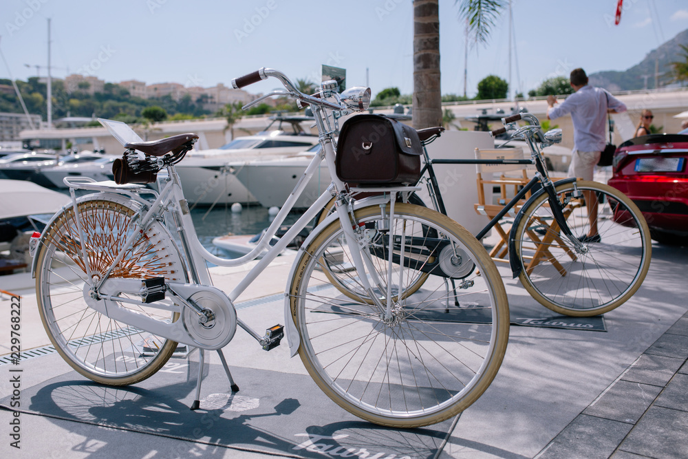 Vintage bicycles by the sea at the pier in monaco monte carlo on the background of yachts and blue sky