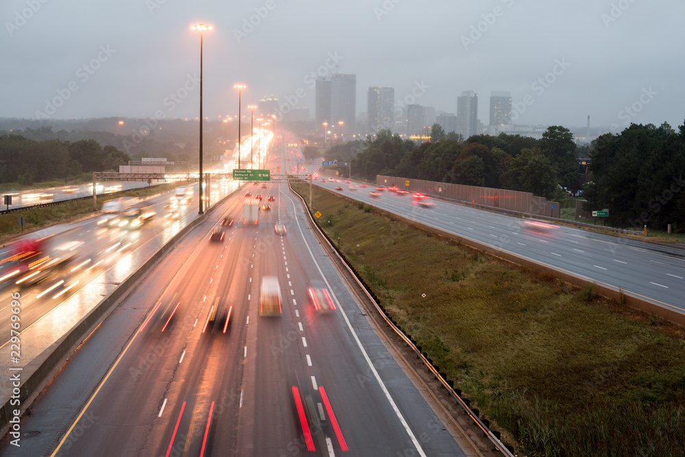 View of highway 401 in Toronto, Canada with the bridge on rainy day