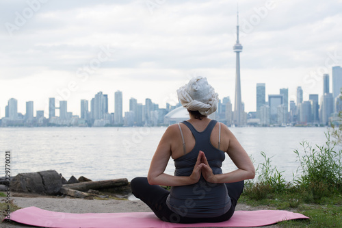 Middle-aged woman practicing yoga at the front of Toronto