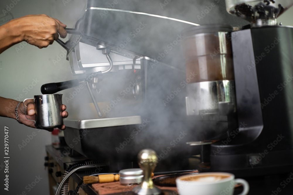 Barista making fresh espresso with a classic Italian coffee machine with steam in background. barista Coffee Maker Machine Grinder Portafilter Concept Barista making fresh espresso with a classic Italian coffee machine with steam in background. barista Coffee Maker Machine Grinder Portafilter Concept