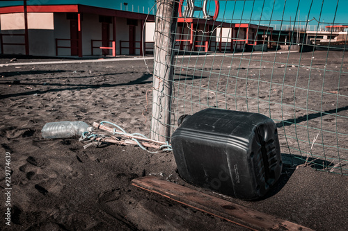 Fototapeta Naklejka Na Ścianę i Meble -  War and political refugee path.Italian beach shore, fenced borders, metal wire, holding migrants and preventing illegal trespassing. Desperation route, hope and freedom concept  for a better life.