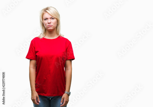 Young beautiful blonde woman wearing red t-shirt over isolated background skeptic and nervous, frowning upset because of problem. Negative person. © Krakenimages.com