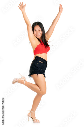 laughing dancing young woman in a trendy outfit