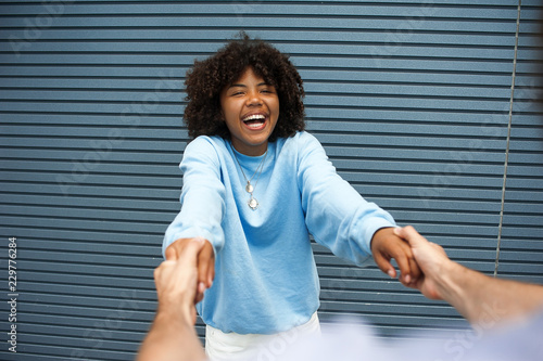 Portrait of happy young girl spinning on a street