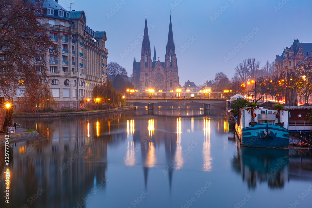 Picturesque landscape with bridge and river Ile embankment in the morning, Strasbourg Cathedral in the background, Strasbourg, Alsace, France