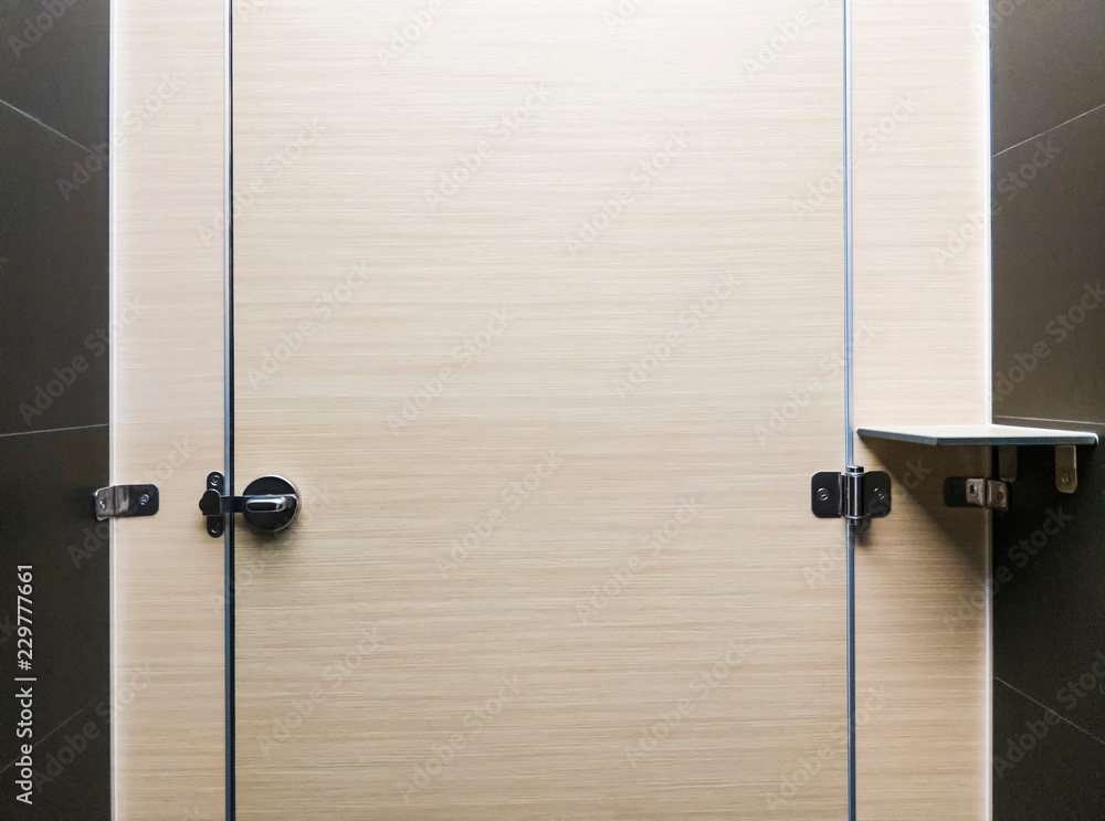 View from a public toilet. While sitting on the toilet bowl. The door