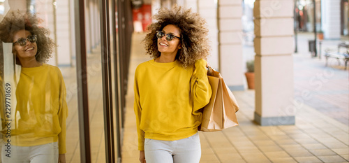Young black woman with curly hair in shopping