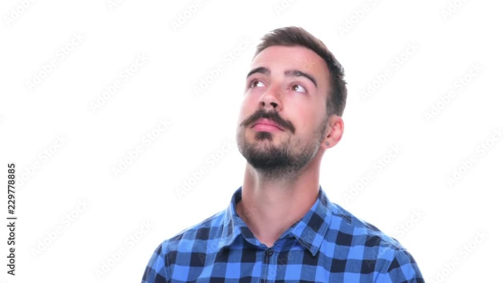 Young relaxed bearded man thinking and looking up isolated on white background. Young relaxed bearded man thinking and looking up isolated on white background.