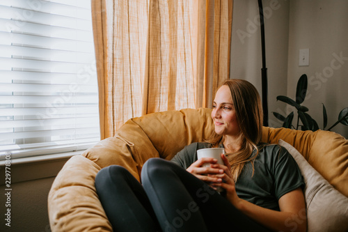 Woman relaxing at home with mug