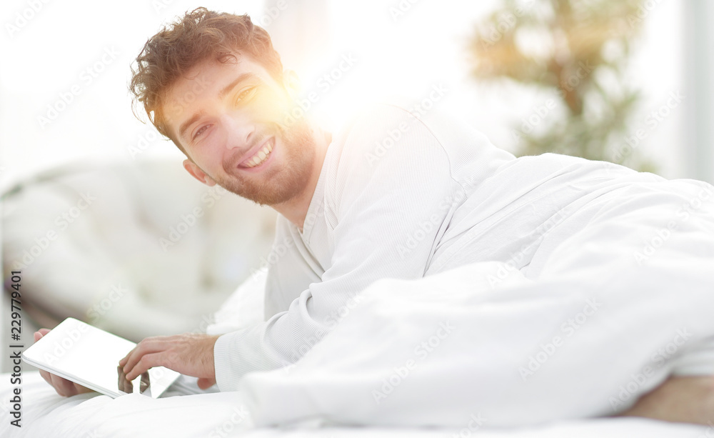 closeup.awakened man typing with a digital tablet closeup.awakened man typing with a digital tablet