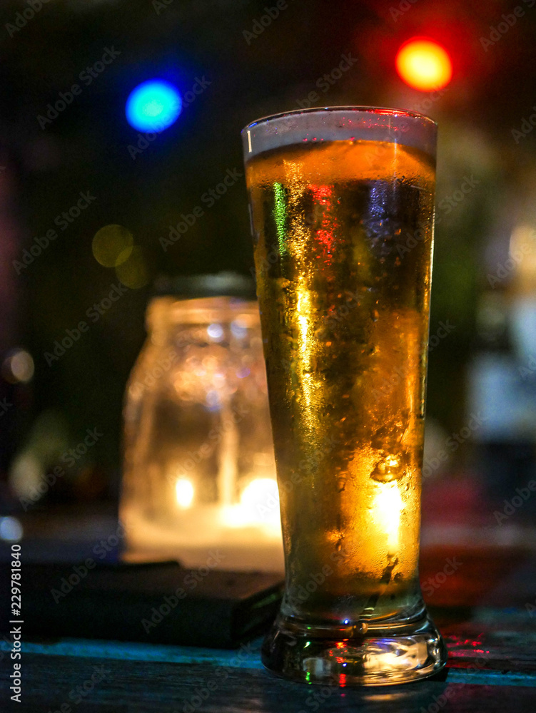 Glass Of Beer In A Illuminated By Candle Light And Colourful Lamps In A Garden Party At Night Stock Photo Adobe Stock Glass Of Beer In A Illuminated By Candle Light And Colourful Lamps In A Garden Party At Night Stock Photo Adobe Stock