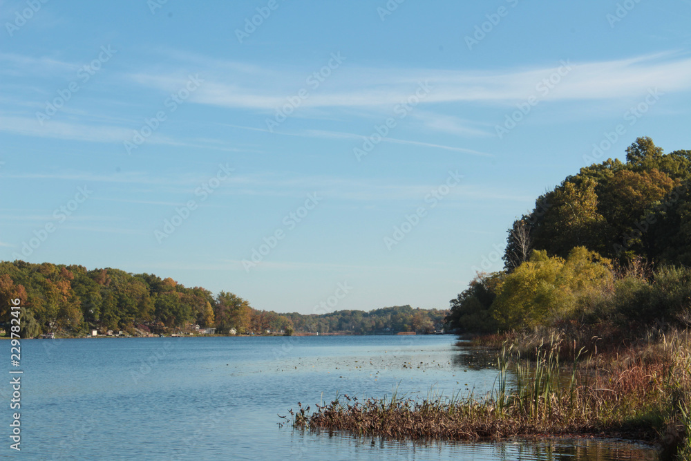 Calm Blue Sky and River With Quaint Country Houses And Yellow Green Autumn Trees