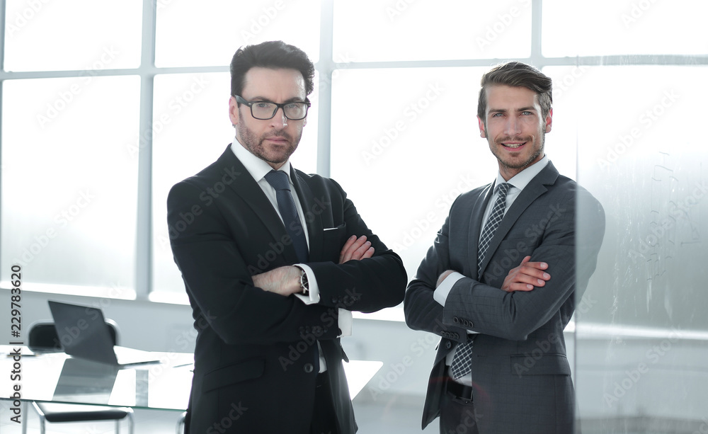 two confident business partners standing in the office two confident business partners standing in the office