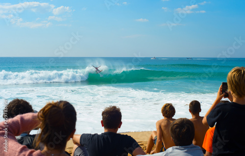 People watching surfing contest beach © joyt