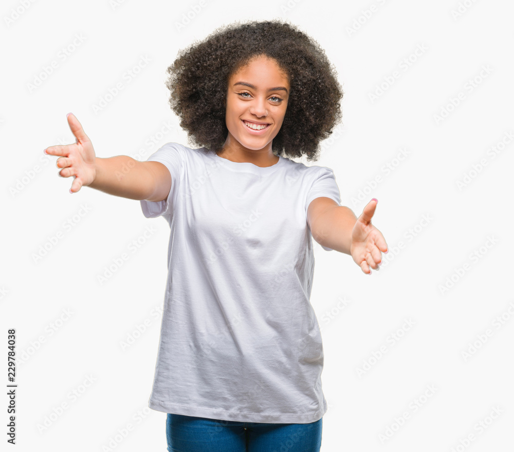Young afro american woman over isolated background looking at the camera smiling with open arms for hug. Cheerful expression embracing happiness. Young afro american woman over isolated background looking at the camera smiling with open arms for hug. Cheerful expression embracing happiness.