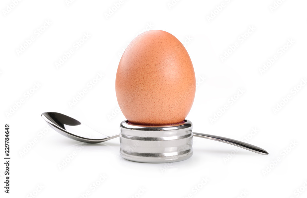 Chicken egg with egg cup and spoon on white background Chicken egg with egg cup and spoon on white background