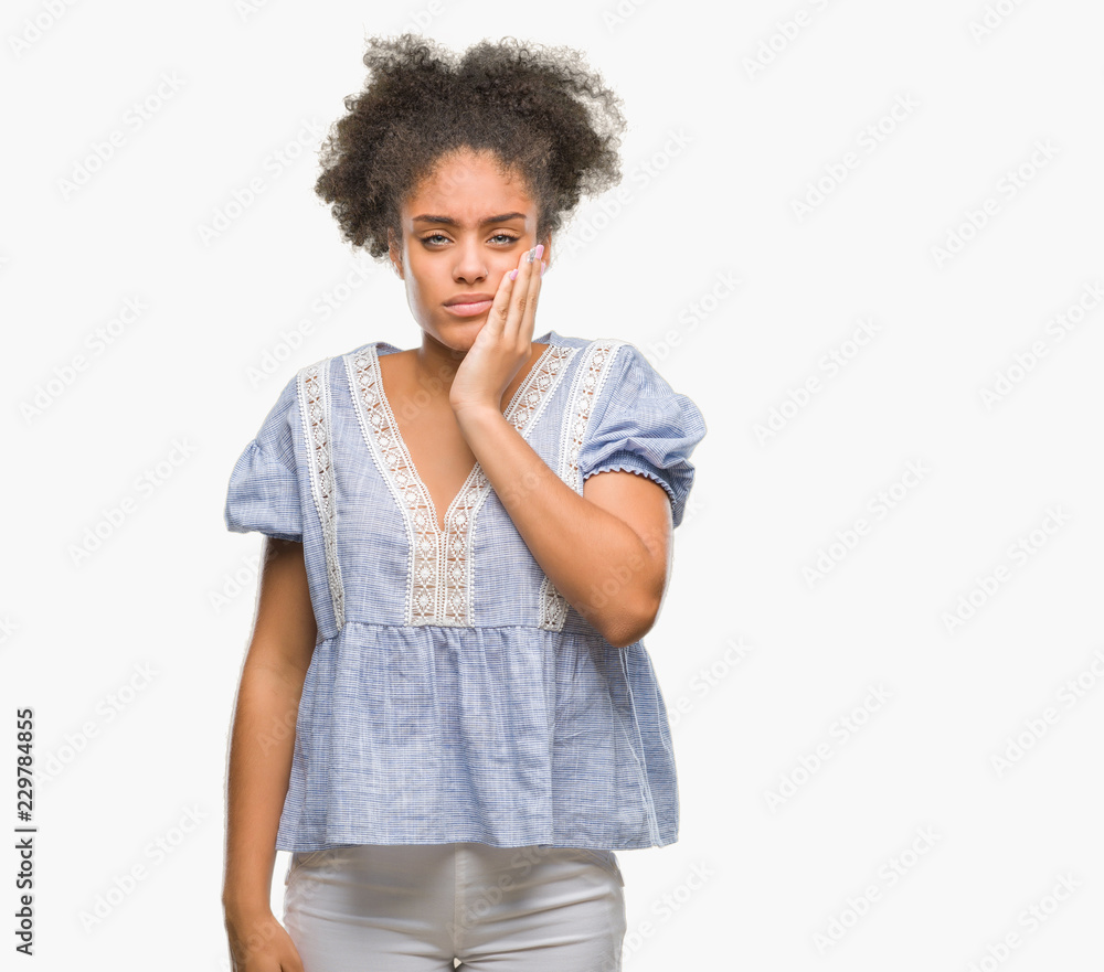 Young afro american woman over isolated background touching mouth with hand with painful expression because of toothache or dental illness on teeth. Dentist concept. Young afro american woman over isolated background touching mouth with hand with painful expression because of toothache or dental illness on teeth. Dentist concept.