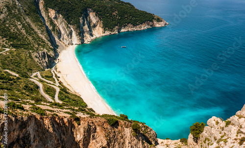 Myrtos beach on Kefalonia island with serpentine road and turquoise Ionian Sea.