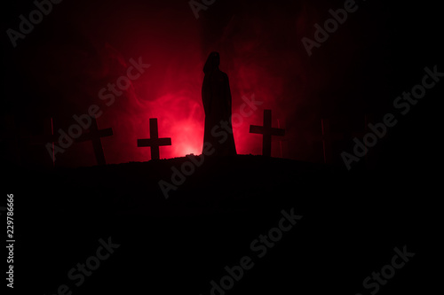 Girl walking alone in the cemetery at night.