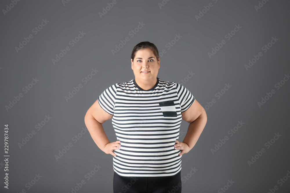 Portrait of overweight woman on gray background Portrait of overweight woman on gray background