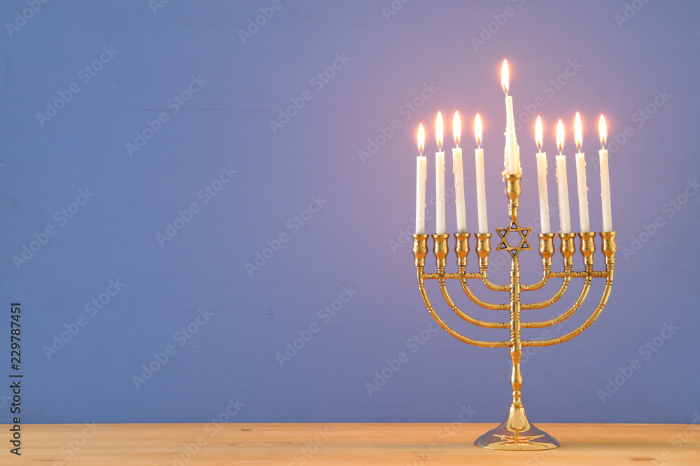 image of jewish holiday Hanukkah background with menorah (traditional candelabra) and candles. image of jewish holiday Hanukkah background with menorah (traditional candelabra) and candles.