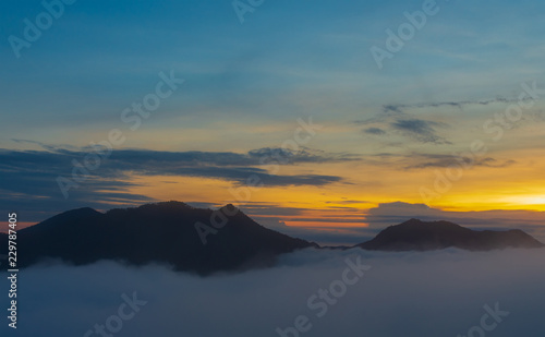 Landscape morning mist of the mountains, beautiful mist and light of the sunrise. © NONTANUN