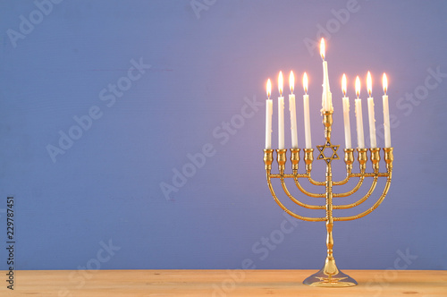 image of jewish holiday Hanukkah background with menorah (traditional candelabra) and candles.