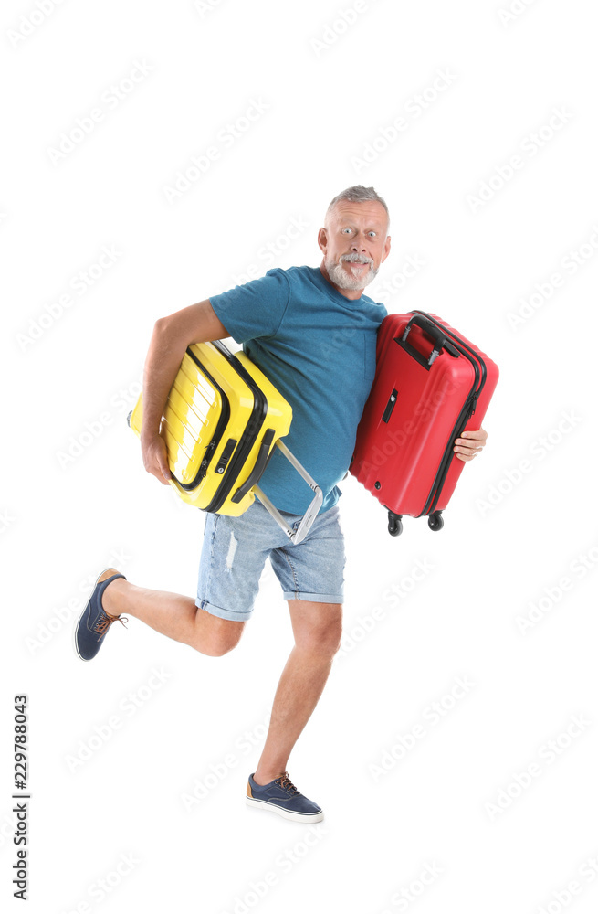 Senior man with suitcases running on white background. Vacation travel Senior man with suitcases running on white background. Vacation travel