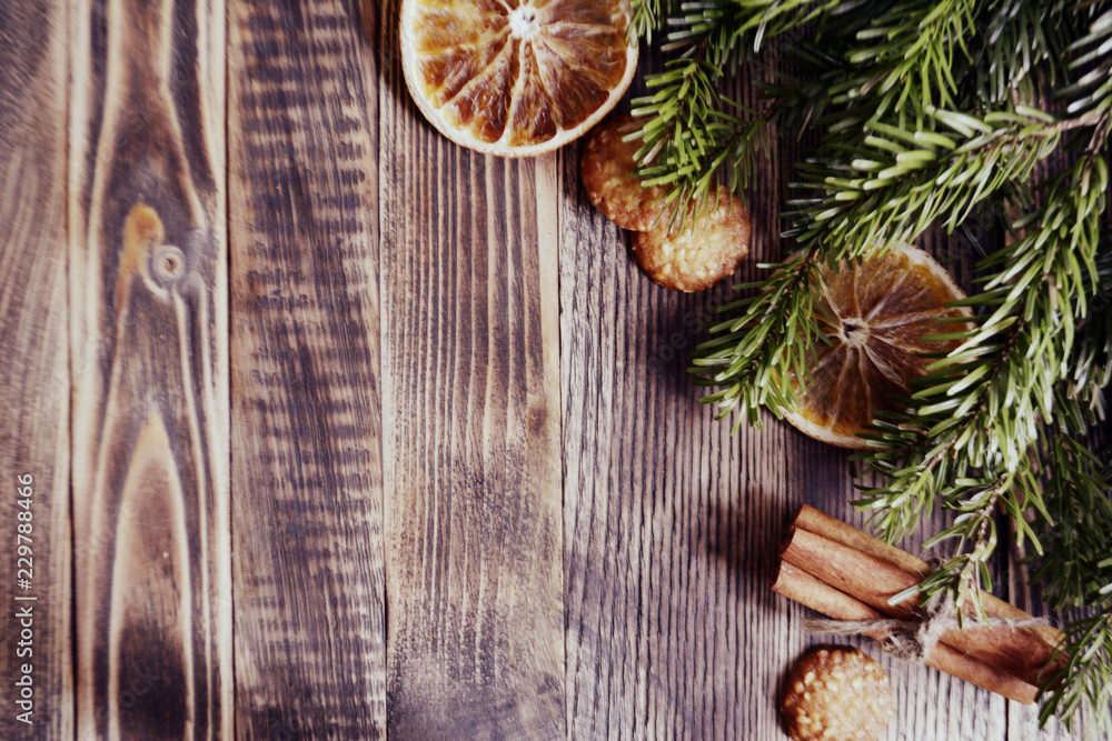 Christmas and new year background frame or postcard Christmas composition with fir branches dried oranges cookies cinnamon sticks on a wooden background Christmas and new year background frame or postcard Christmas composition with fir branches dried oranges cookies cinnamon sticks on a wooden background