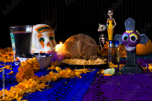 Ofrenda de día de muertos. Con calavera de azúcar, pan de muerto y platillo tradicional mexicano 7 photo