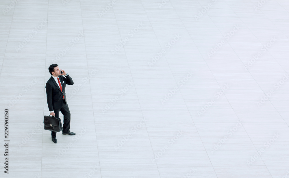 top view from afar.Businessman talking on a mobile phone top view from afar.Businessman talking on a mobile phone