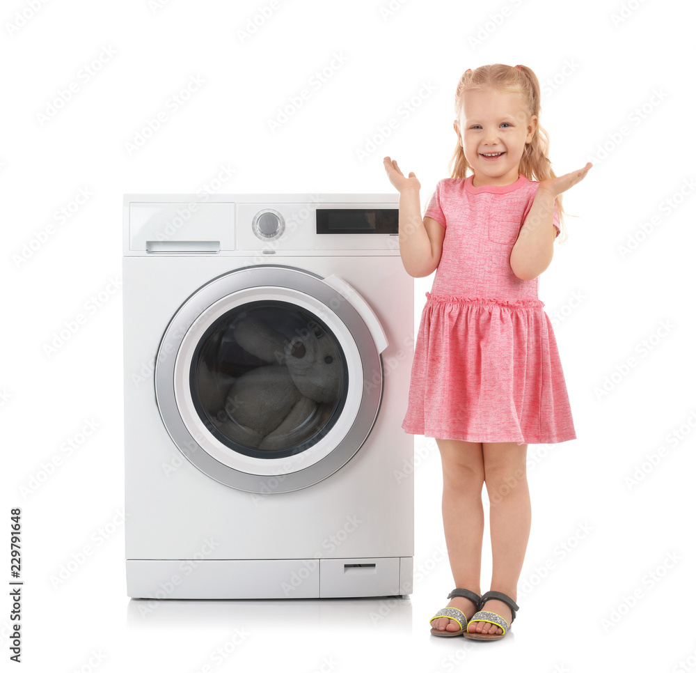 Cute little girl standing near washing machine on white background. Laundry day Cute little girl standing near washing machine on white background. Laundry day