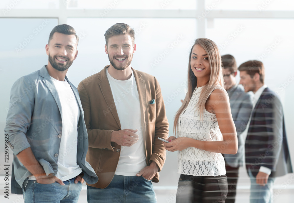Obraz premium three young employees of the company standing in the office