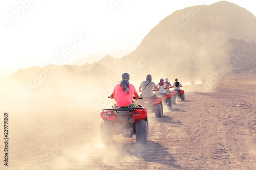 Desert in Egypt. Sharm el Sheikh. Sand and Sand Borkhan. Rock and sunset. Quad Cycle Travel. Excursion with people. photo