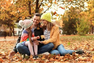 Happy family with child together in park. Autumn walk