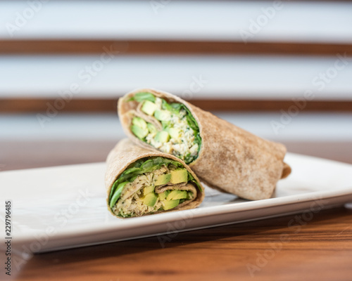 An avocado and chicken wrap cut in half