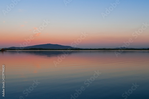 Reflection of Sleza Mountain in Mietkow Lake at sunset in Lower Silesia  Poland